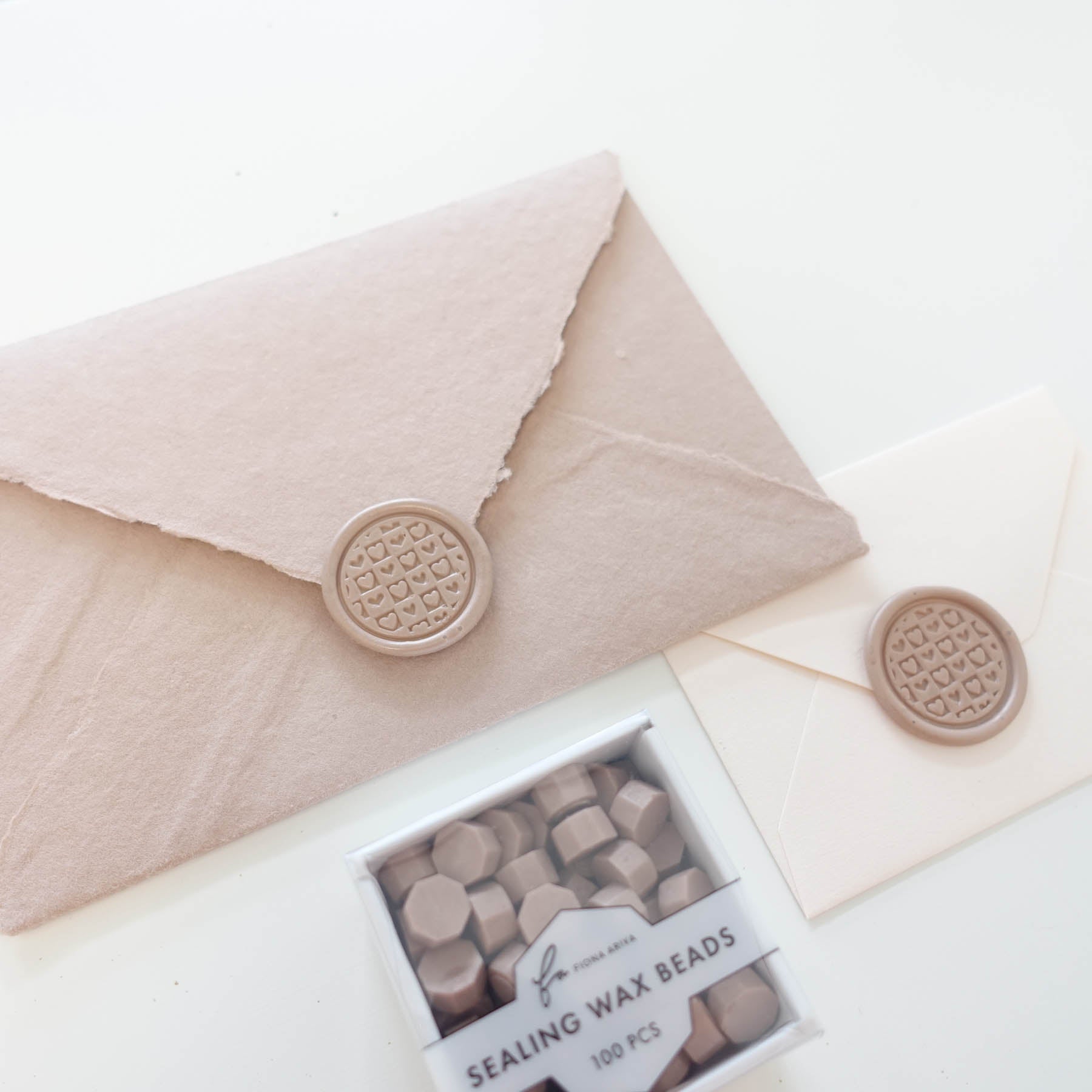 chequered hearts patchwork pattern wax seal with dusty rose taupe sealing wax beads fiona ariva australia