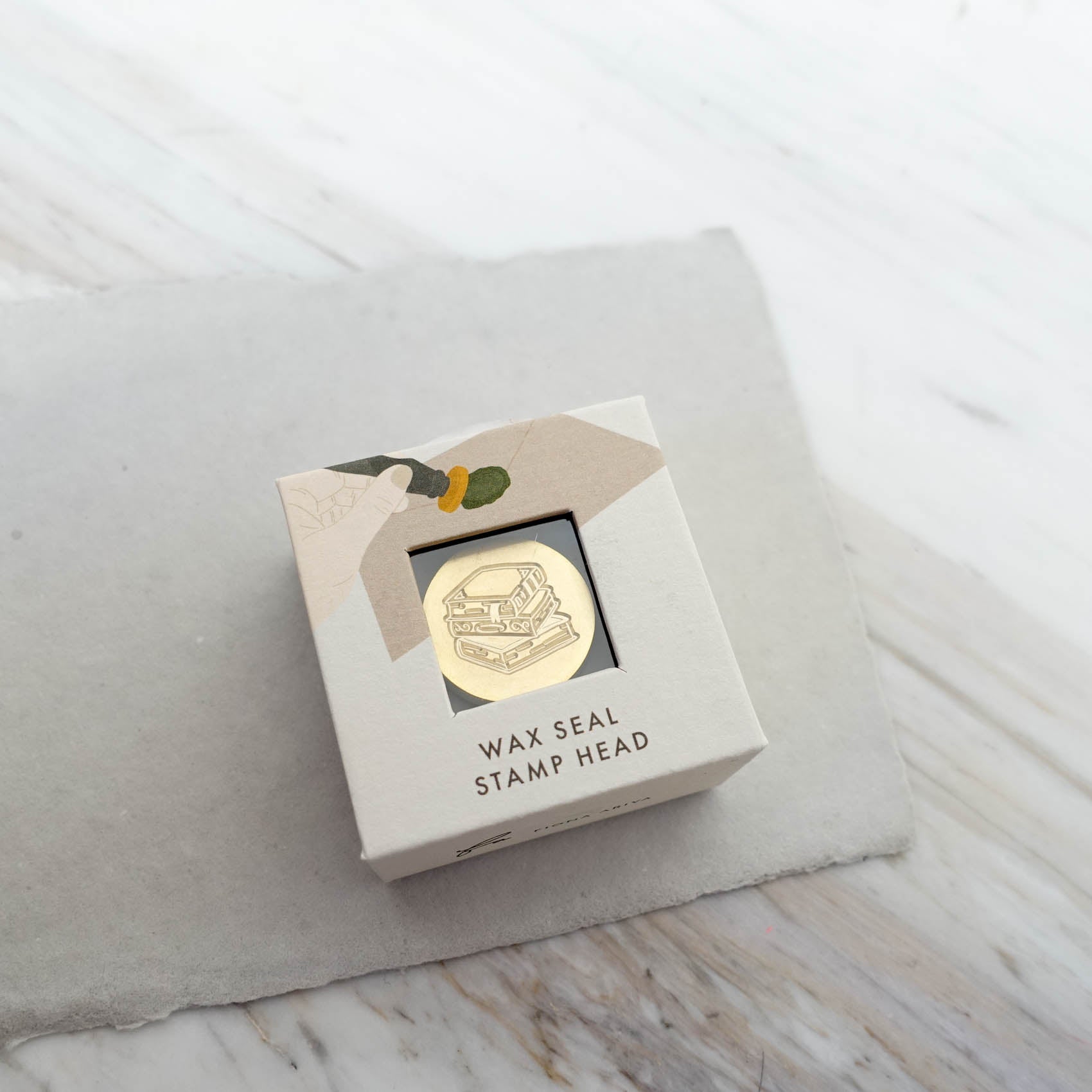 stack of books wax seal stamp head fiona ariva australia