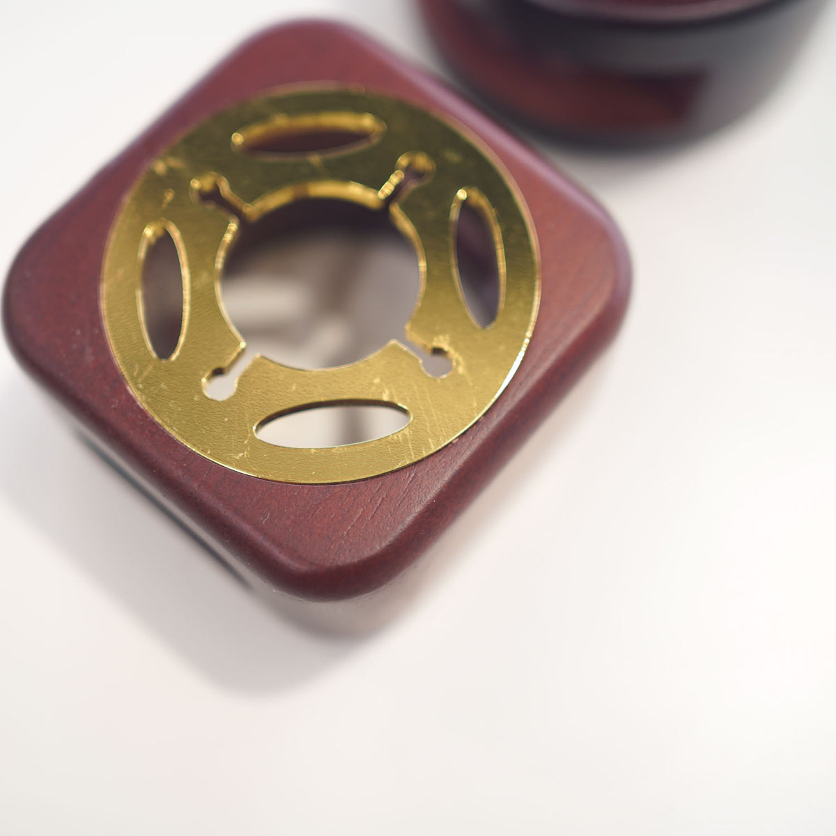 Close-up of rose gold deco cut-out spoon holder stove top