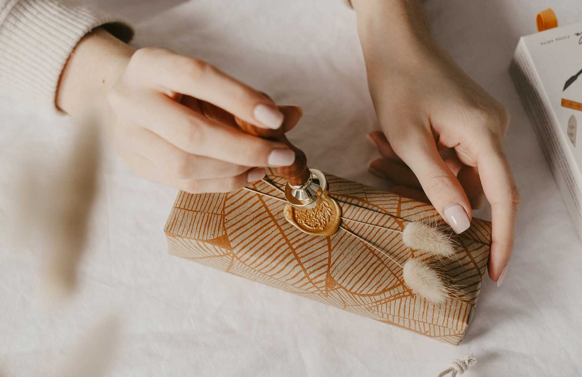 Wax seal stamps, sealing wax and stationery laid out on a desk