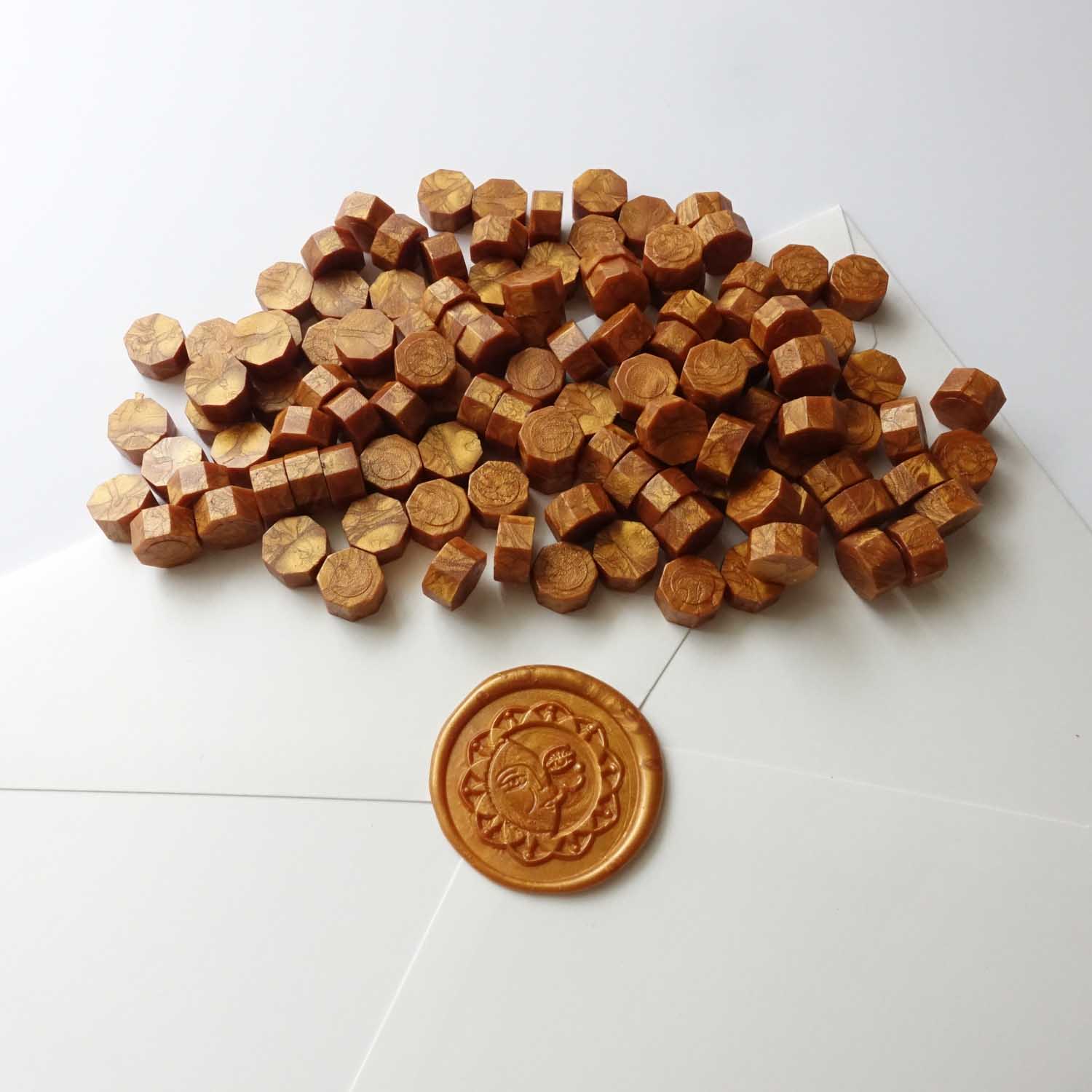 Amber gold sealing wax beads with sun wax seal on envelope