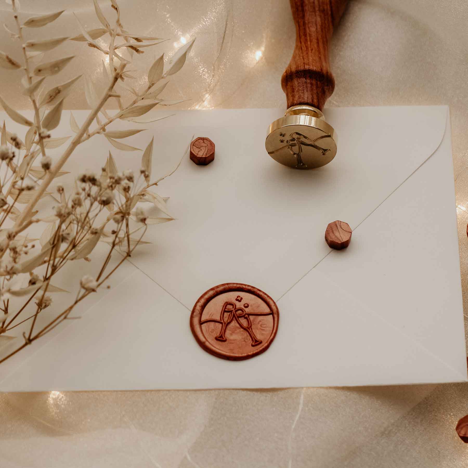clinking champagne glasses celebration wax seal on enevelope fiona ariva australia