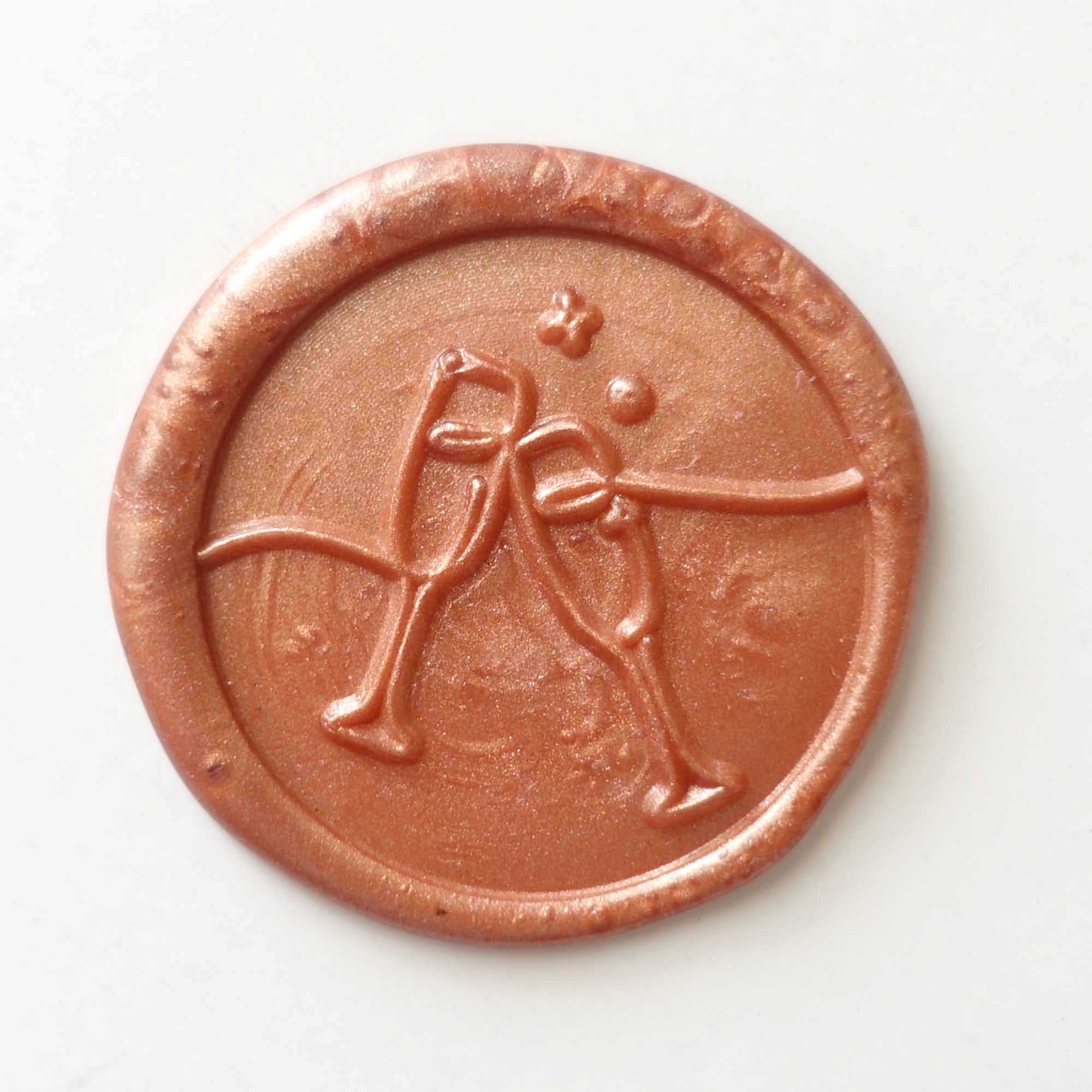 clinking champagne glasses celebration wax seal peach copper fiona ariva australia