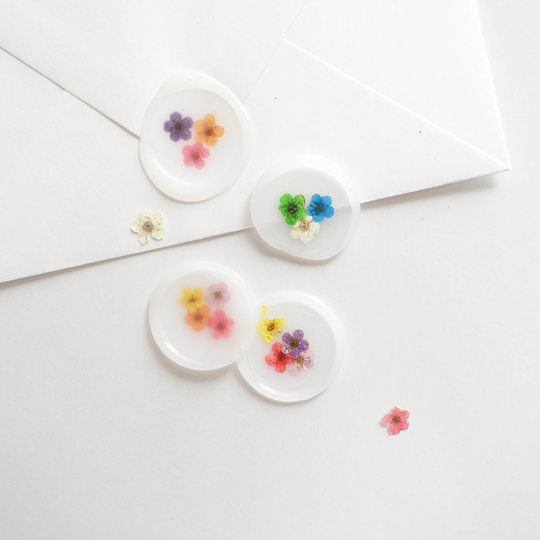 tiny dried flowers with semi transparent wax