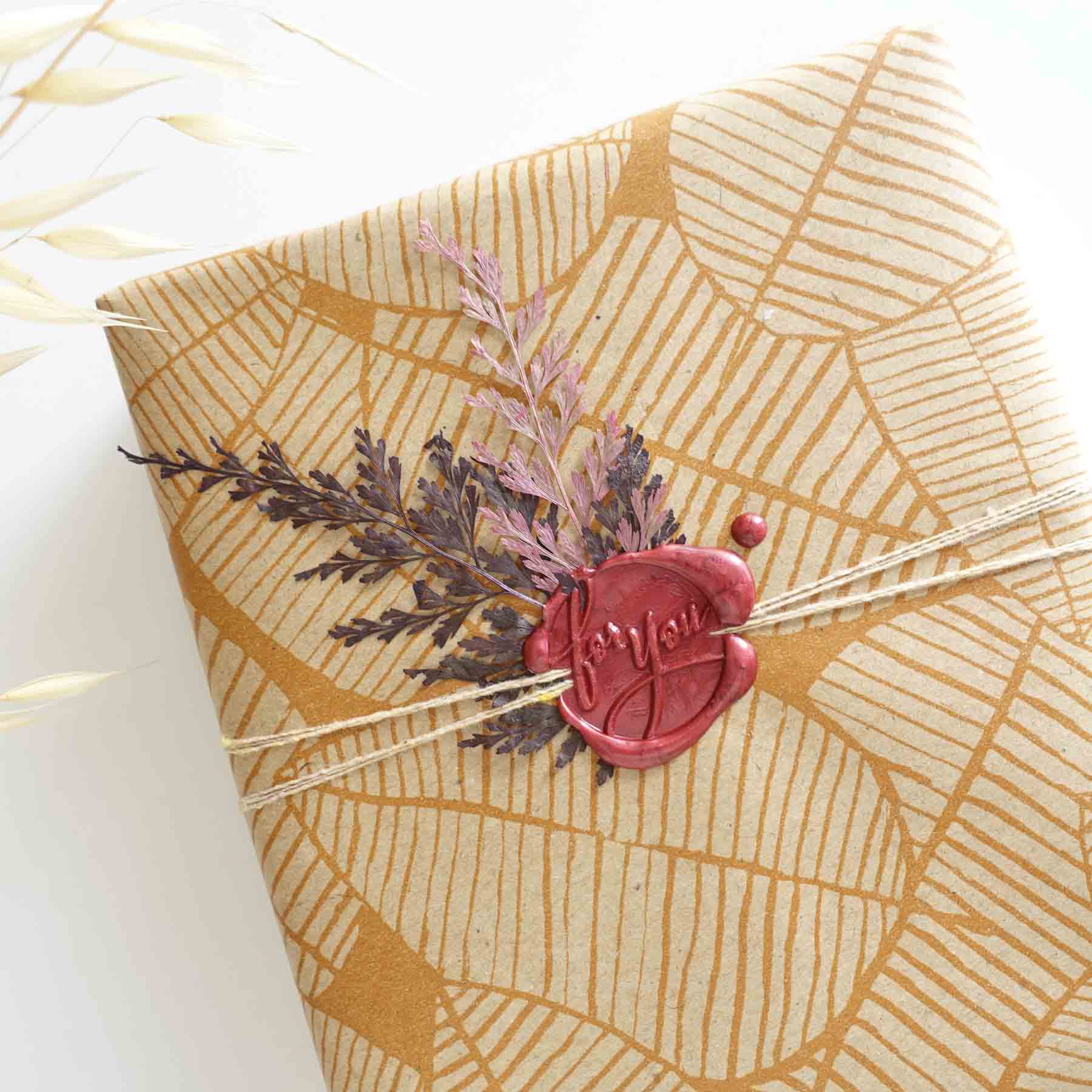 Gift wrapping idea with for you red wax seal and dried pressed fern leaves