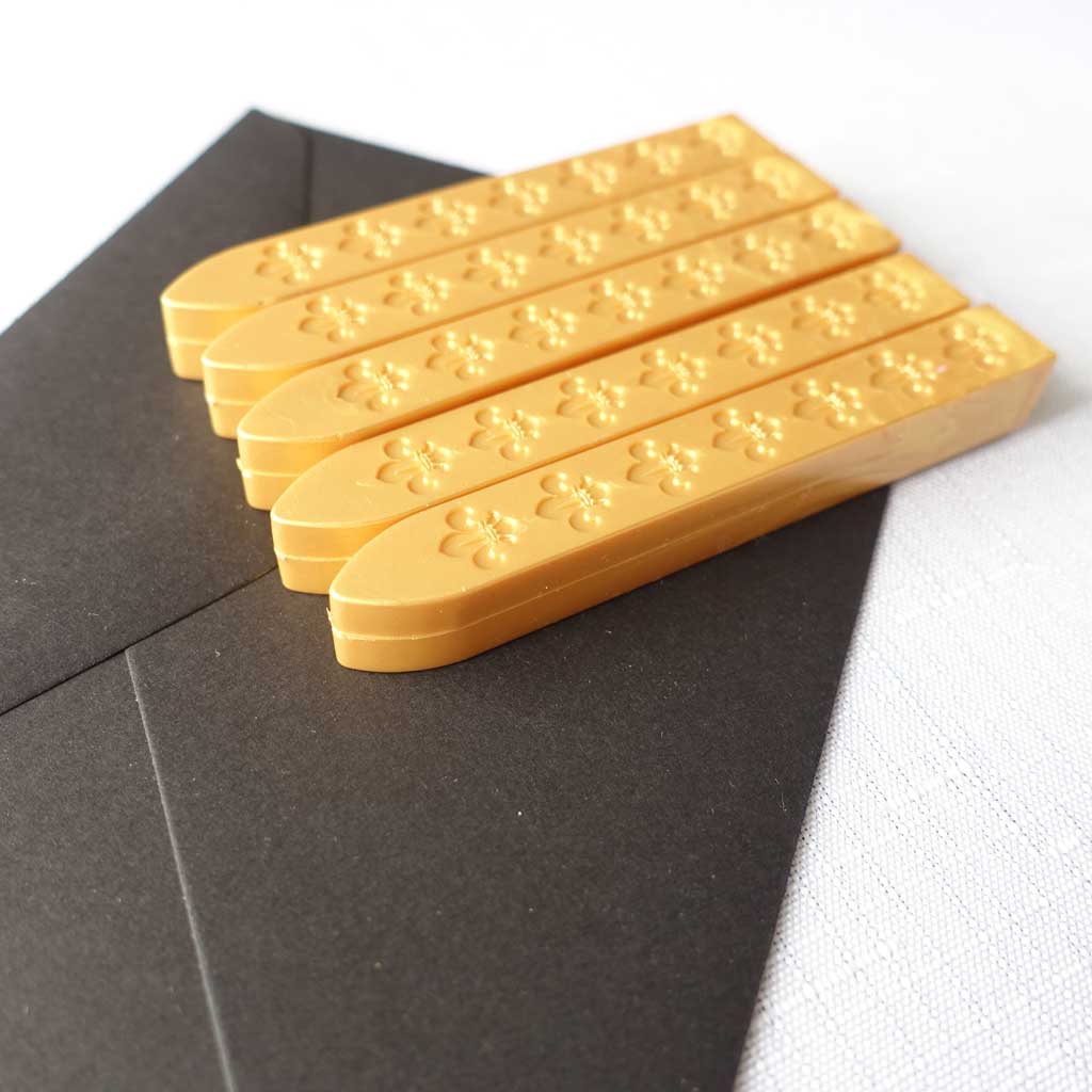 5 pack of wickless wax sticks for wax seals in a yellow gold metallic colour