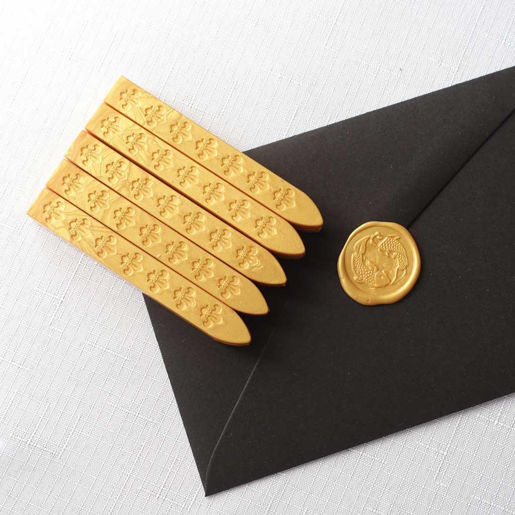 5 pack of wickless wax sticks for wax seals in a yellow gold metallic colour