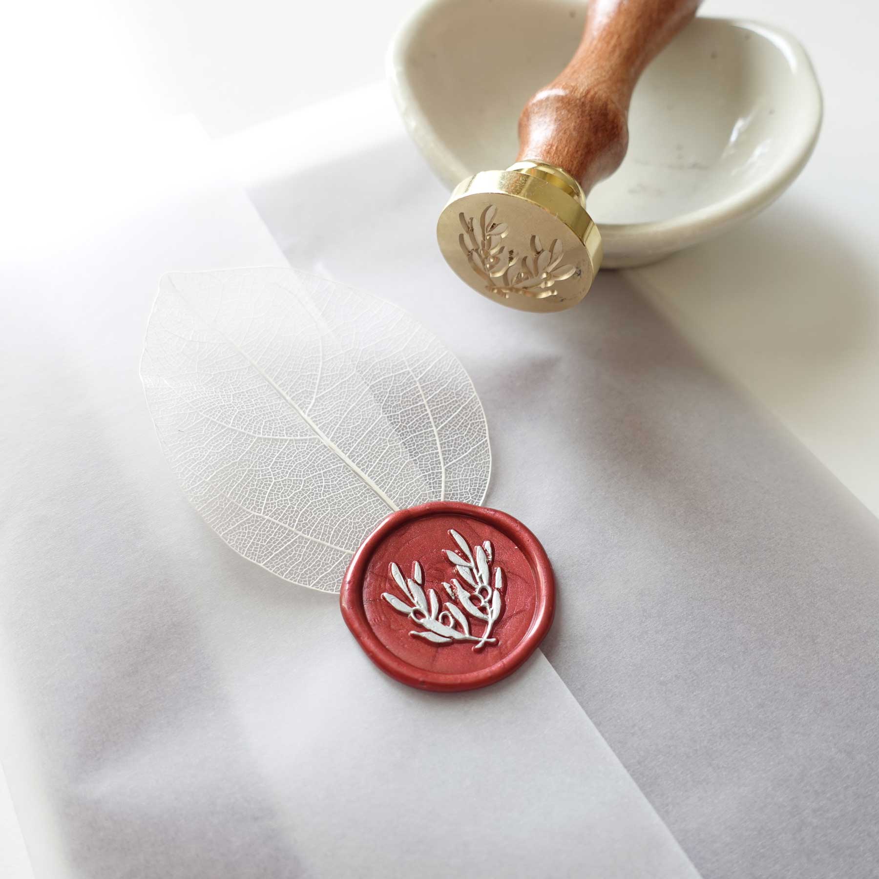olive leaves laurel red wax seal with white skeleton leaf