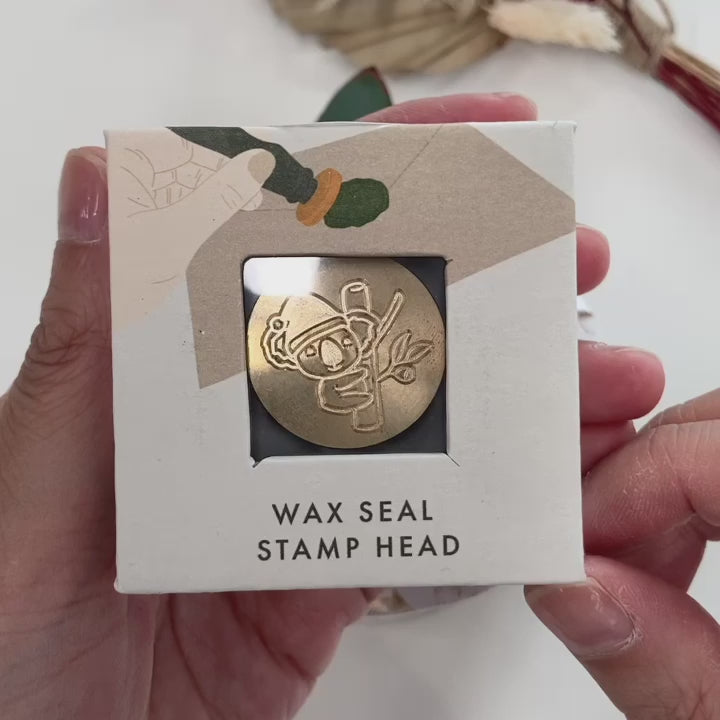 christmas koala wax seal stamp with gift wrapping and eucalyptus leaves