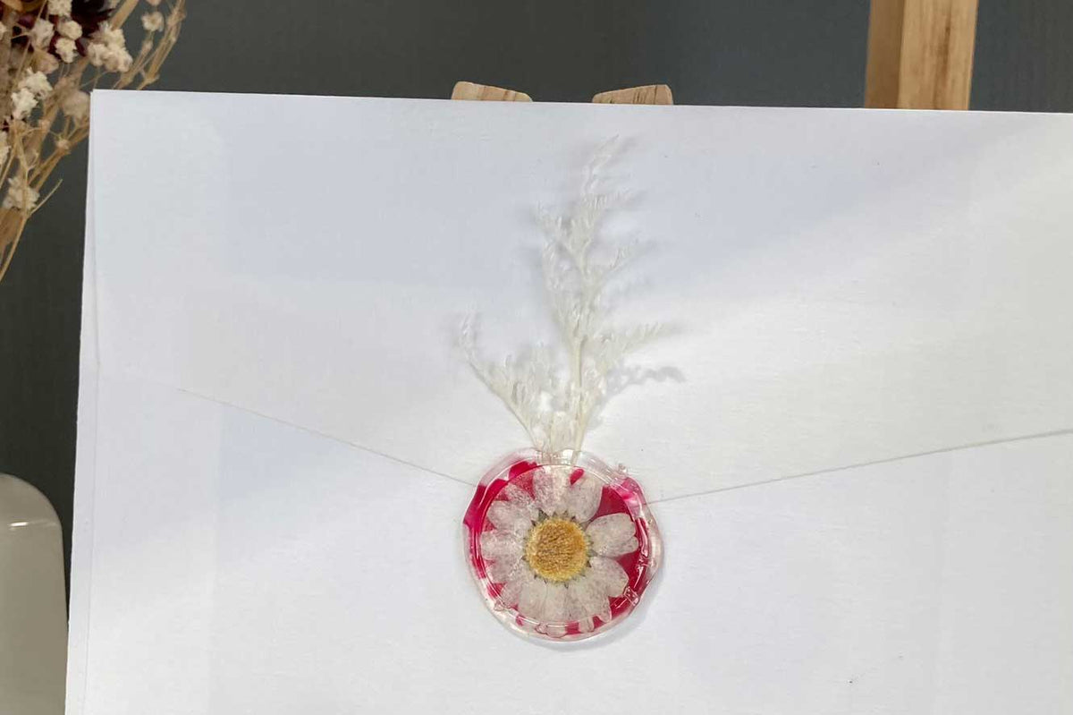 Wax seal with dried flowers on a card