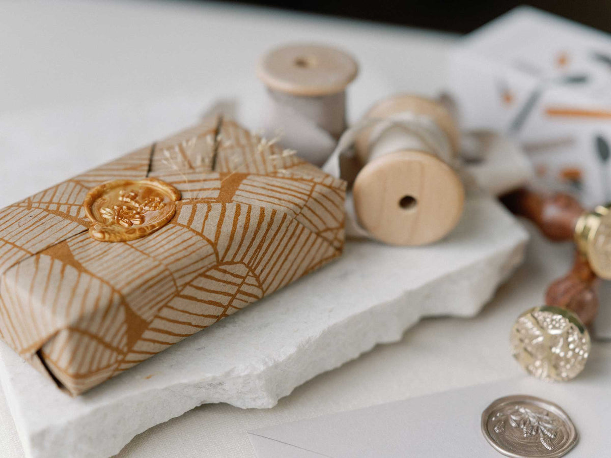 Gift wrapped with a gold wax seal