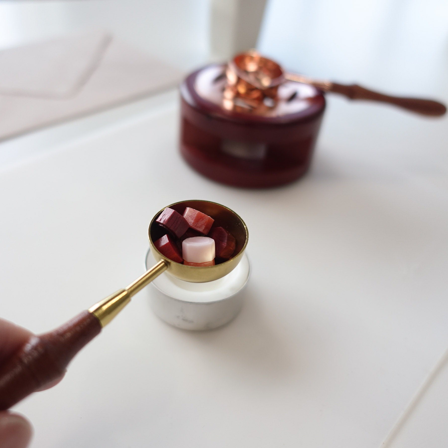 Step 3: wax sealing tools including a melting spoon and candle