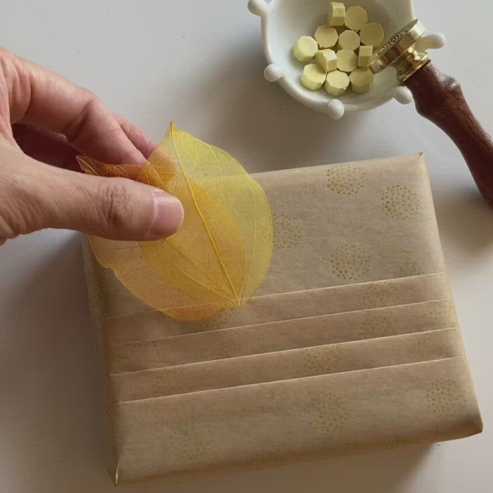 golden wattle yellow wax seal gift wrapping idea with dried leaves