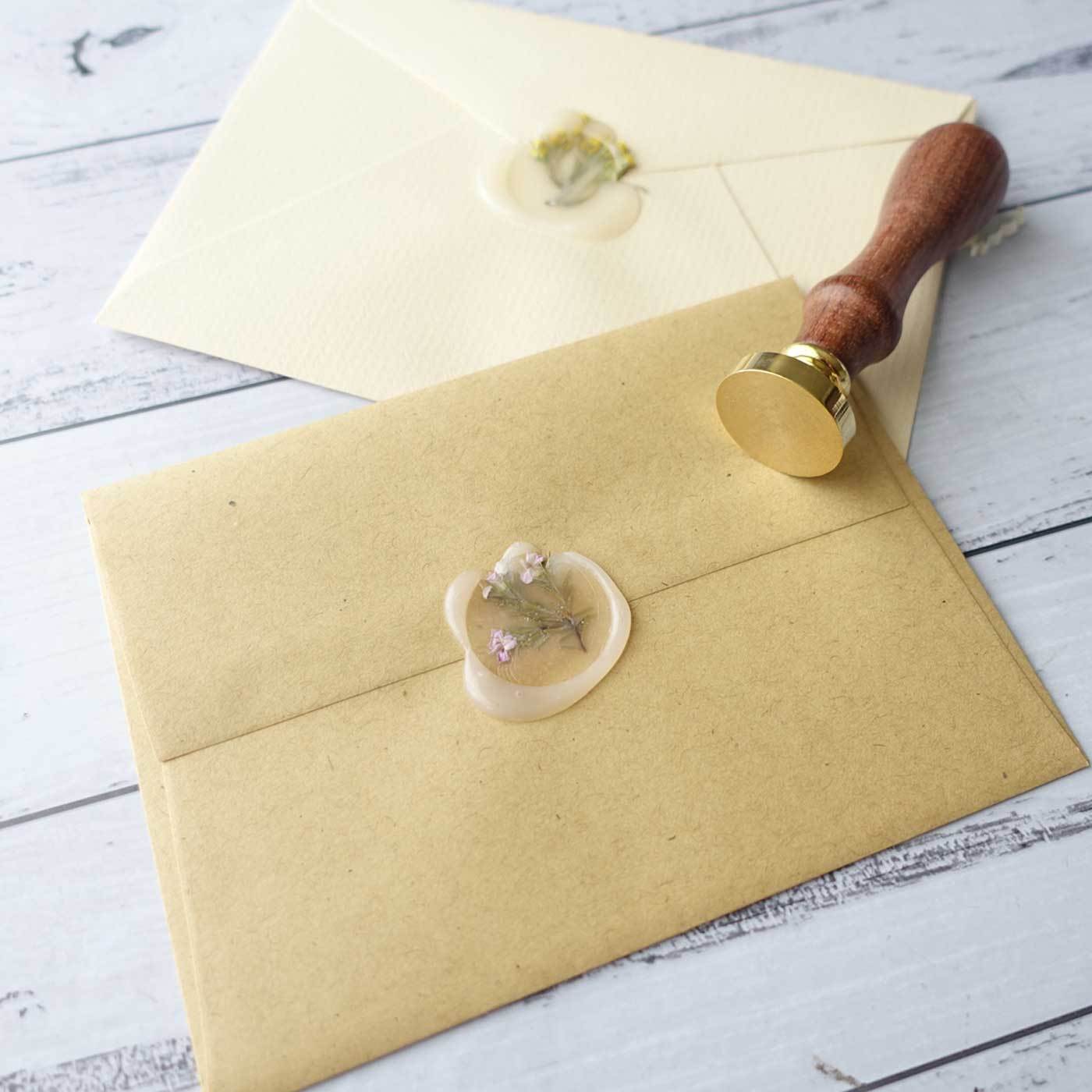 Semi transparent wax seal with flowers on envelope with blank wax seal stamp