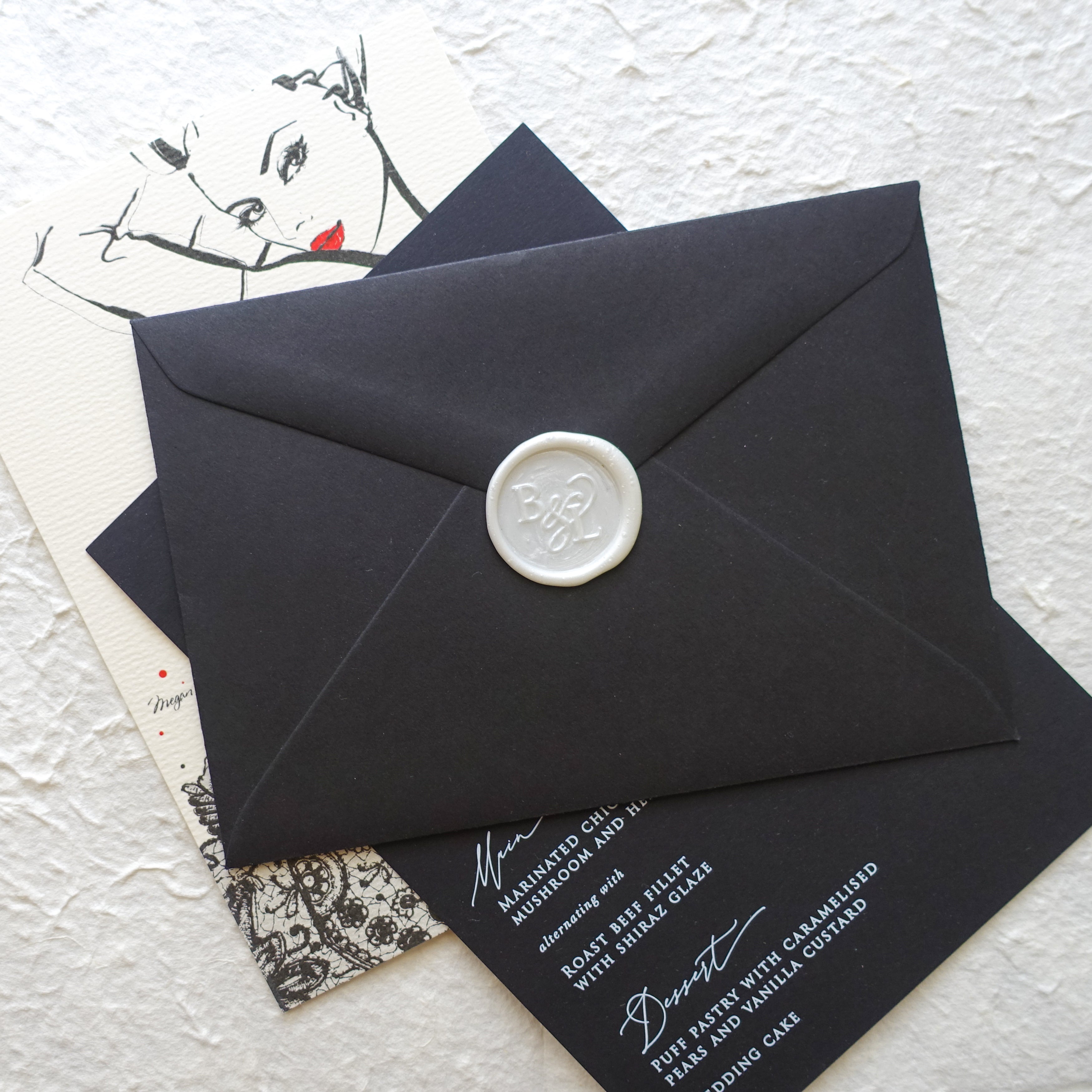 Monogram wedding wax seal on black envelope