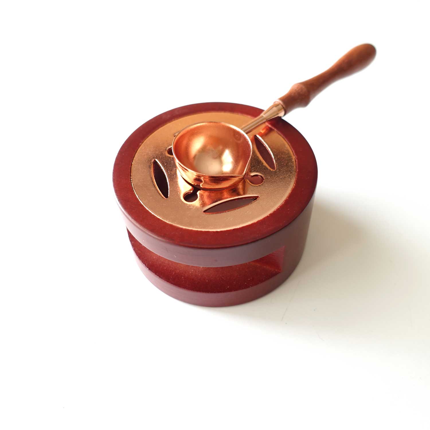 Rose gold spoon on spoon holder stove