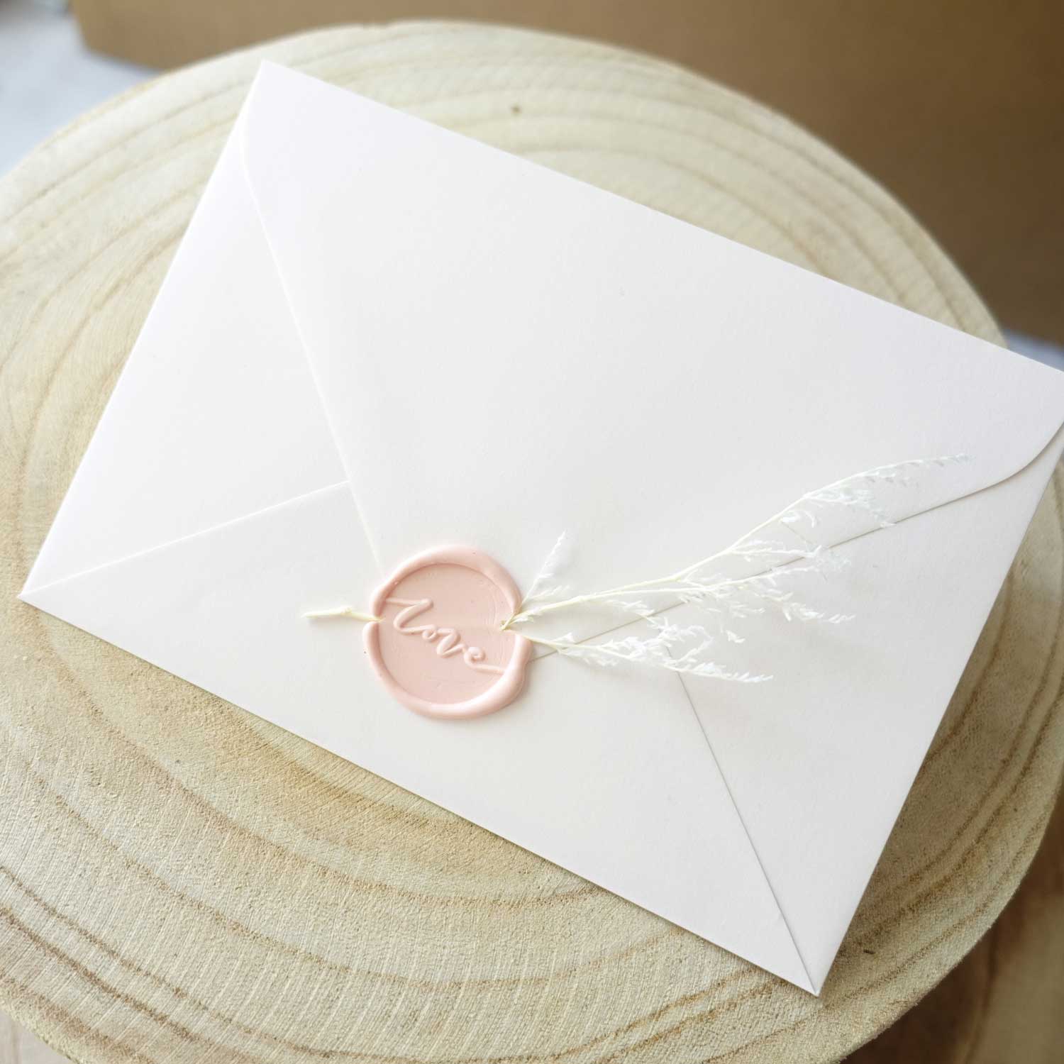 pink love wax seal on envelope with foliage