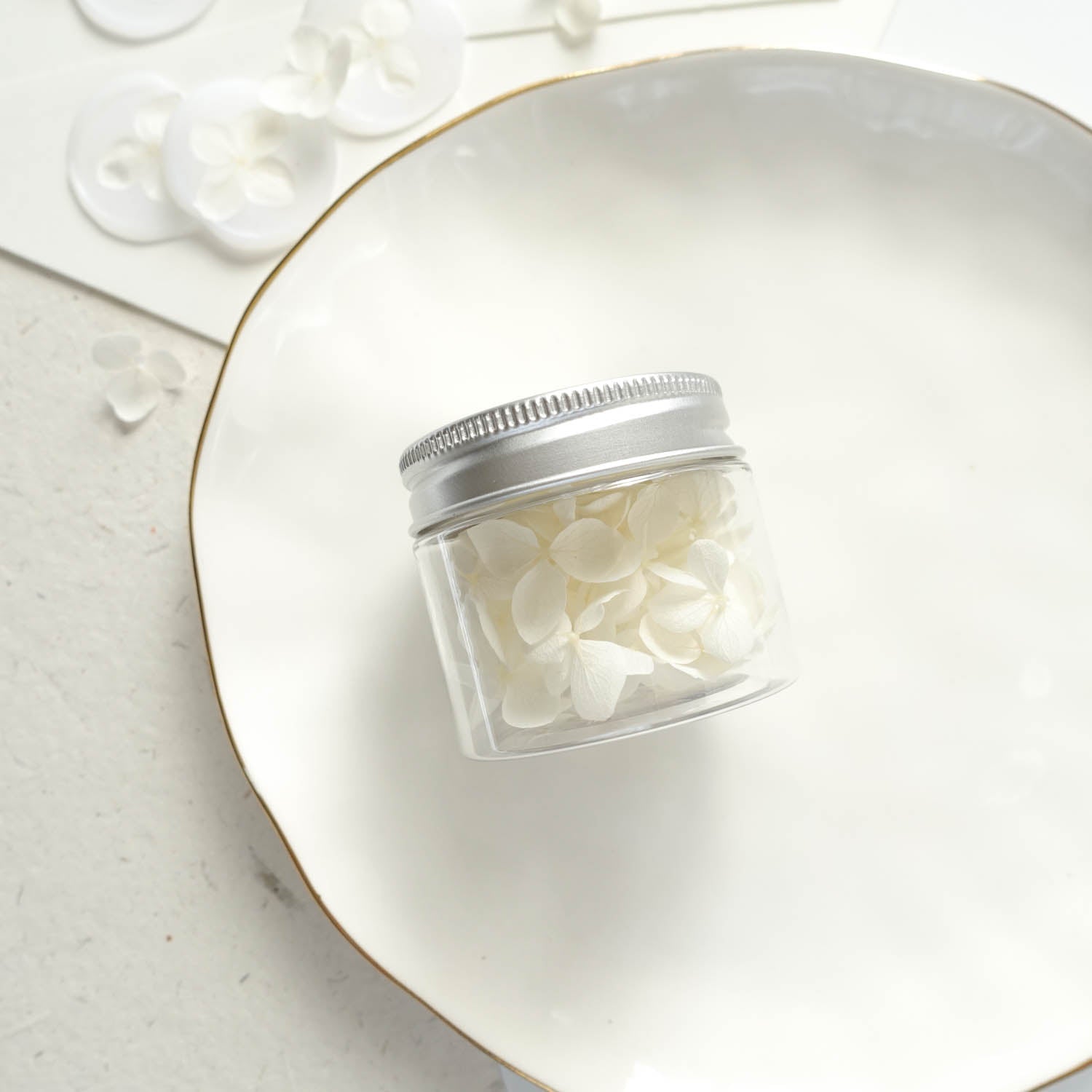 white dried hydrangea flower petals jar