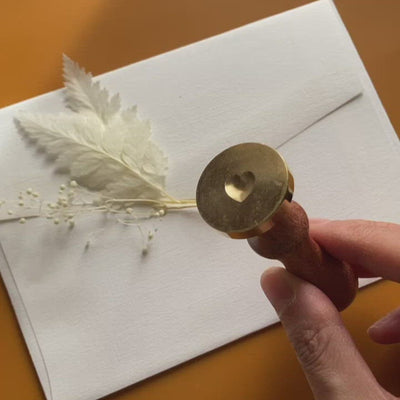 Video of 3d heart wax seal with dried flowers on envelope