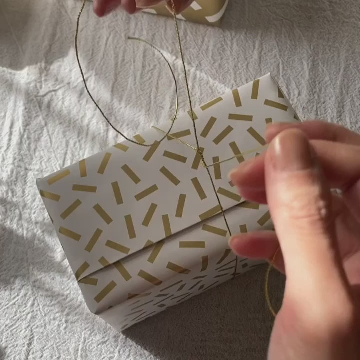 gold twine gift wrapping idea with wax seal stamp